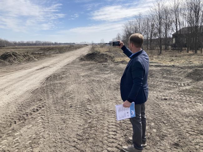 Man taking photo of an empty lot