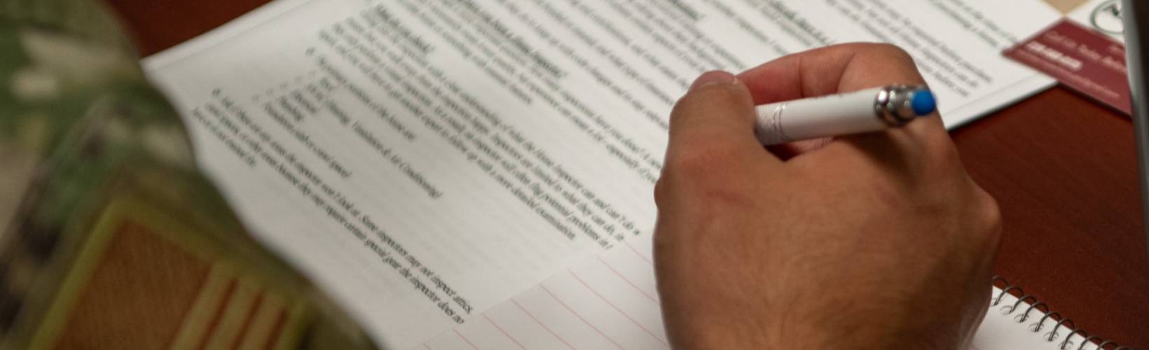 Hand filling out paperwork