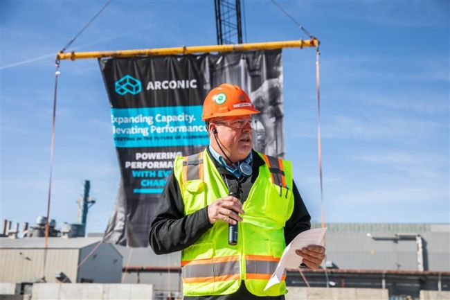 Man with hard had talking at a construction site ground breaking