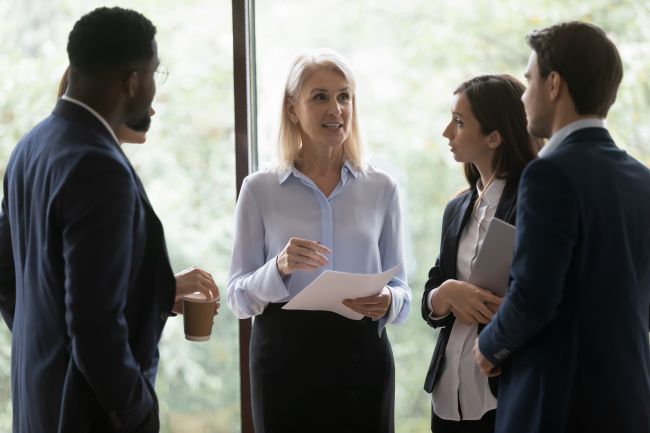 Women talking to a group of employees