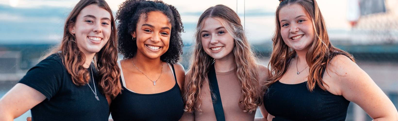 Four females smiling