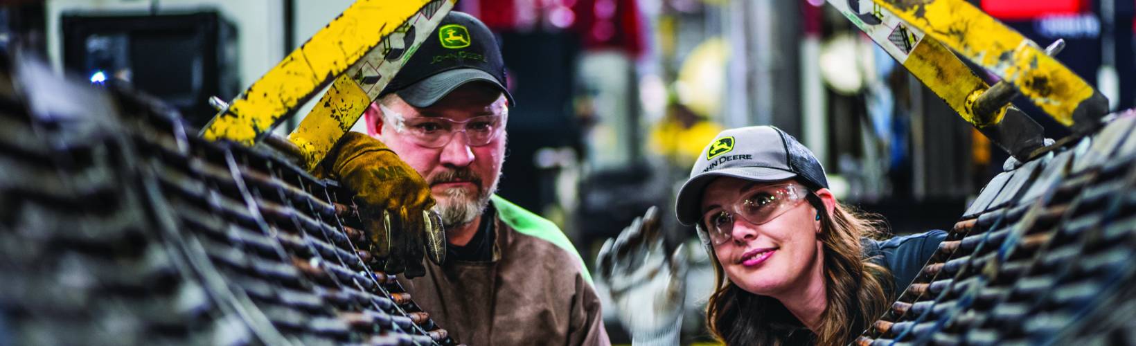 Two employees looking at machinery